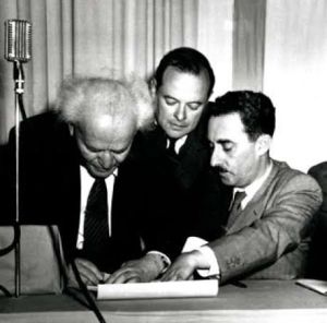 David Ben-Gurion signs the Declaration of Independence on May 14, 1948. Moshe Sharett is on the right